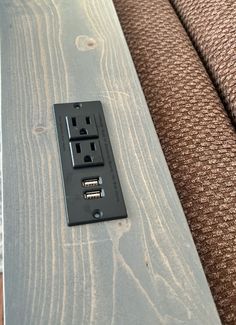 an electrical outlet on the side of a couch