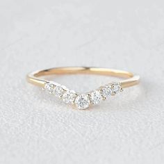 a gold wedding band with three diamonds