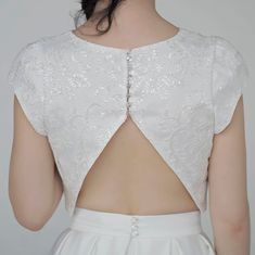 "The elegant and classy \"Aiko\" crop top features sparkly sequined lace mounted onto a matte ivory bridal satin, and it has wide fit cap sleeves, open triangle back and clear buttons. It is only available in shown ivory color. We recommend wearing backless bra with this top. Pair this top with any or our bridal bottoms: https://www.etsy.com/shop/WardrobeByDulcinea?ref=l2-shop-info-name%C2%A7ion_id&section_id=19306135 We would be needing these measurements from you and here are the instructi Elegant Fitted Tops For Weddings, Elegant Short Sleeve Party Crop Top, Elegant Short Sleeve Crop Top For Party, Elegant Sleeveless Lace Crop Top, Elegant Wedding Tops With Boned Bodice, Elegant Sleeveless Crop Top For Wedding, Elegant Crop Top With Boned Bodice, Elegant Sleeveless Crop Top With Lace, Elegant Lace Wedding Bodice