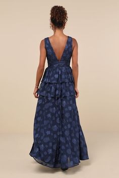 the back of a woman wearing a blue dress with hearts on it and a v neckline