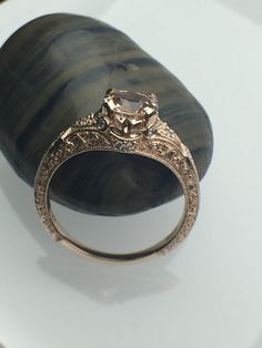 a fancy ring sitting on top of a rock