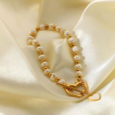 Product name: Freshwater Pearl Heart Pendant OT Buckle Bracelet Material: Titanium steel, Freshwater Pearl Size: length 190mm Packaging: gift box Color: gold Product weight: 11.84g Remarks Statement: We use vacuum furnace electroplating for color plating, and the material is also selected 316 titanium steel, no discoloration, no rust, no allergy, no black, wear-resistant, green and environmental protection Gold Heart-shaped Pearl Bracelet For Valentine's Day, Gold Pearl Bracelet With Heart Charm, Gold Pearl Bracelet With Heart Beads For Valentine's Day, Gold Pearl Bracelet With Heart Beads, Gold Pearl Bracelet For Valentine's Day, Gold Heart-shaped Pearl Bracelet With Heart Beads, Gold Pearl Bracelet With Heart Charm As Gift, Gold Adjustable Pearl Bracelet For Valentine's Day, Valentine's Day Gift Gold Pearl Bracelet