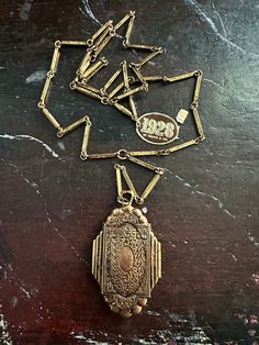 Goldtone double locket victorian resurgence by 1928 with paper label circa 1960s (late)and very rare. of this period. Measures 24 inch neck, with a 5.5 inch drop with pendant for a 15. 5 inch total drop. Pendant measures 2 in. tall by 1.25 in. wide. All sales final. Victorian Locket Necklaces For Vintage Events, Collectible Art Deco Locket Necklace, Antique Medallion Necklace For Vintage Events, Vintage Antique Gold Collectible Jewelry, Vintage Antique Gold Jewelry Collectible, Vintage Antique Gold Jewelry For Collectors, Antique Gold Vintage Locket Necklace, Vintage Antique Gold Medallion Necklace Gift, Antique Gold Vintage Jewelry For Collectors