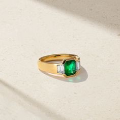 18kt Yellow Gold Luxury Three Stone Octagon Ring, Luxury Octagon Three Stone Ring, Modern Emerald-cut Green Diamond Ring, Green Three Stone Baguette Cut Ring, Green Baguette Cut Three Stone Rings, Modern Emerald Rings With Baguette Cut, Modern Diamond Ring For May Birthstone, Modern May Birthstone Diamond Ring, Green Emerald Ring With Three Stone Baguette Cut