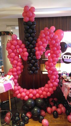 a table topped with balloons in the shape of an i love you sign on top of it