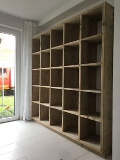 an empty bookcase in front of a sliding glass door