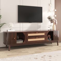 an entertainment center with a flat screen tv mounted on it's sideboard in a living room