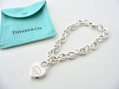 Overview: Offered for sale is a wonderful and gorgeous Return to Tiffany & Co. Sterling Silver Heart Padlock Charm Bracelet. Definitely a Tiffany piece that you will get your money's value for. It works perfectly with pretty much any attire your put on, AND is a great statement piece. The piece looks fabulous worn alone, but is also a wonderful piece with which to start or add to your Tiffany collection. The Heart Padlock charm opens and closes so you can take it off the bracelet and wear it Pandora Bracelet Charms Ideas, Tiffany And Co Bracelet, Return To Tiffany, Expensive Jewelry Luxury, Heart Padlocks, Bracelet Charms, Jewelry Luxury, Pandora Bracelet Charms, Expensive Jewelry