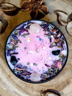 a bowl filled with lots of different types of things on top of a wooden table