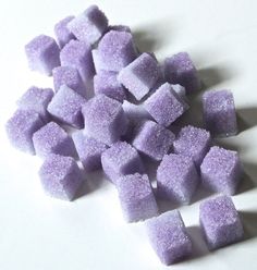 purple sugar cubes sitting on top of a white table