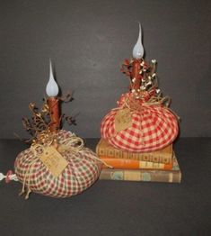 two decorative pumpkins sitting on top of books