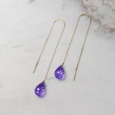 "\"A gold pair of threader earrings with a beautiful purple amethyst! February's birthstone is believed to bring warmth and strength to the person wearing it. They would make a unique birthstone gift for someone you love. Light and easy to wear all day long! Are they for you? Perfect! Simple and sophisticated, these earrings are aiming to make your day stable and peaceful!\" --Fairy Goldcharm ♥♥ CUSTOMIZATION ---> Available in yellow, white, or rose gold. ---> Isn't amethyst your birthston Dainty 14k Gold Purple Jewelry, Dainty Purple 14k Gold Jewelry, Yellow Gold Amethyst Briolette Jewelry, Yellow Gold Briolette Amethyst Jewelry, Fine Jewelry Briolette Earrings As Gift, 14k Gold Briolette Jewelry With Matching Earrings, 14k Gold Filled Threader Earrings As Gift, 14k Gold Dangle Threader Earrings For Formal Occasions, Yellow Gold Threader Earrings As A Gift