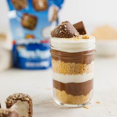 a jar filled with desserts sitting on top of a table