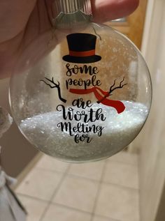 someone is holding up a glass ornament that says some people are worthing for