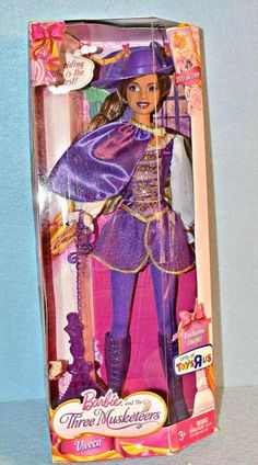 the barbie doll is wearing a purple outfit and holding a wand in her hand,