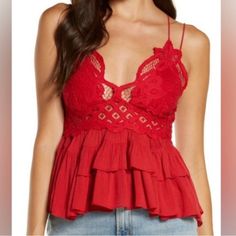 Red Lace Bralette Cami With Flowy, Tiered Bottom Design And Intricate Crochet Lace Top Crisscross Straps A-Line Silhouette Lined Bust Stretchy Back Panel Intimately Free People Bust: Approximately 14 Inches Pit To Pit (But Has Stretchy Back Panel) Length: Approximately 21 Inches Hand Wash Cold Viscose, Nylon And Cotton Red, Cherry, Casual, Dressy, Boho, Bohemian, Strappy Sleeve, Spaghetti Strap, Western, Beach, Country, Cottagecore, Lace, Knit, Crotchet B2 Fitted Red Top With Lace Trim, Fitted Red Tops With Lace Trim, Red Lace Tops For Spring, Red Lace Trim Tops For Spring, Red Lace Top For Summer, Red V-neck Top With Lace Trim, Red Fitted Lace Top, Red Lace Tops For Summer, Red Sleeveless Feminine Top