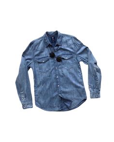 "Description:  It's an authentic blue denim shirts, featuring hand distressed and ripped detailing, twin pockets, long sleeves, snap buttons closure, vintage style 80s. It's perfect to wear on every occasion and season in climate where weather is just too warm. Also, it can be worn as outerwear by putting it open over a T-shirt or tank. Details: - Blue denim. - Snap Buttons. - Double chest pockets. - Self-distressed Jeans. Condition: Very good.  Size: S (on tag) - Length (centre of back neckline to bottom): 29\" - Armpit to armpit: 40\" - Shoulder to shoulder: 17.5\" - Sleeves (shoulder to cuff): 25.5\" Gender: Unisex.  Recommendation for: all seasons and casual outfits. Material: Cotton, Denim, Jeans. *Note: Please check the measurements before making a payment so that you can ensure it w Distressed Dark Wash Long Sleeve Top, Blue Denim Slim Fit Shirt, Distressed Button-up Shirt For Fall, Distressed Long Sleeve Shirt Relaxed Fit, Blue Stonewashed Long Sleeve Denim Jacket, Distressed Cotton Button-up Shirt, Distressed Long Sleeve Shirt For Spring, Casual Fitted Distressed Shirt, Western Style Blue Denim Shirt