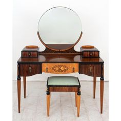 an antique dressing table with mirror and stool