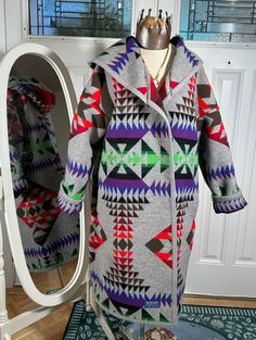 Yes, this is a Pendleton blanket that I upcycled into this gorgeous coat.  Unfortunately I cannot use the Pendleton name in the title. Warm and comfy, Pendleton does not make a long coat with a hood, but I do  I have designed a cut for Pendleton blankets that incorporates the binding all along the edges of my coat.  Bottom hem, up both front panels and all around the hood.  I've gotten really good at utilizing that gorgeous Pendleton pattern and matching it at the seams do make sure to zoom in. Pendleton Pattern, Pendleton Blankets, Wool Blanket Coat, Pendleton Blanket, Langer Mantel, Wool Blanket, Long Coat, Wool Coat, Fashion Fashion