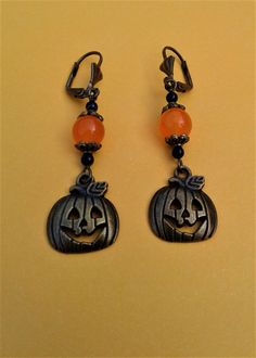 "Pumpkin Halloween Earrings Halloween Jewelry Antique Bronze Pumpkin Jack O Lantern Charms Fall Autumn Orange Topaz Black Onyx Gemstones Halloween Earrings!!  These Antique Bronze Pumpkin Charm Earrings are a must for you to wear this year. 2 Friendly Jack O Lanterns. The Pumpkin Charm itself measures 5/8 \" wide and 3/4 \" in height. The total length of the earrings measure 2 1/8 \" from the ear post to the tip of the earring. The earrings include:  Antique Bronze Lever Backs - Antique Bronze P Pumpkin Jack O Lantern, Autumn Orange, Jack O'lantern, Earrings Halloween, Pumpkin Jack, Jewelry Antique, Halloween Earrings, Pumpkin Halloween, Halloween Jewelry