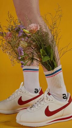 a pair of white nike sneakers with flowers in the bottom and number 6 on them