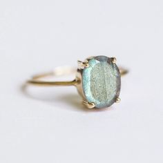 How can something so simple as an oval Labradorite solitaire ring, be so beautiful you ask? The answer is in the gemstone itself. With a gorgeous silvery-green color, this ring just pops out on your finger and dazzles everyone. To turn it up a notch, add complimentary stacking rings, to create a one-of-a-kind ring set - something extra special for yourself or your loved one. Details: Center Gemstone: Labradorite Stone Shape: Oval Measurements: approx. 9x7 mm Weight: approx 1.75 ct Band measureme Planet Ring, Moss Agate Ring, Baguette Ring, Rose Quartz Ring, Demi Fine Jewelry, Labradorite Ring, Agate Ring, Swiss Blue Topaz, Quartz Ring