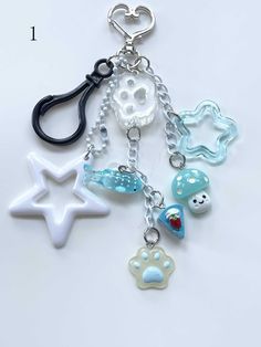 a keychain with various charms attached to it's sides, including a dog paw