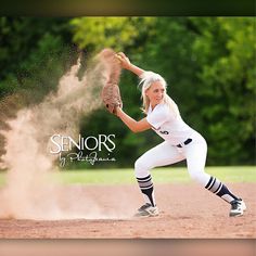 a female baseball player throwing a ball on top of a field with trees in the background