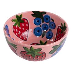 a pink bowl with blueberries and strawberries painted on it