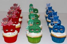 some cupcakes with different designs and characters on them are lined up in rows