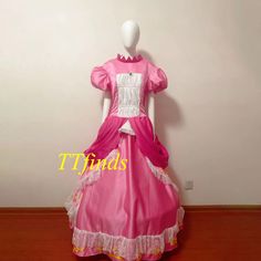 a pink and white dress on a mannequin's head with the words tridis above it