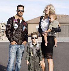 a man, woman and child are standing in the street