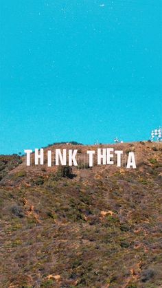 a sign that says think thea on top of a hill