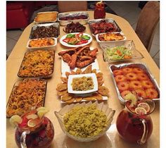 a table filled with lots of food on top of it's sides and plates