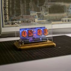 an alarm clock sitting on top of a wooden stand