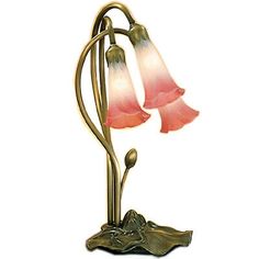 a lamp that is on top of a metal stand with two flowers in the middle