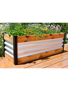 a wooden planter filled with lots of plants