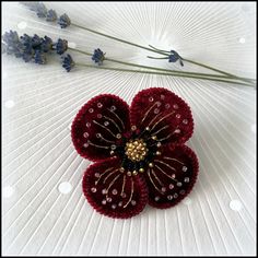 This lovely handmade brooch can be worn for any occasion, adding an instant lift to your wardrobe. Made with deep red crushed velvet and beads. Every petal is individually embroidered with gold metallic thread and beads and supported by wire on the inside, so may be bend in the way you like it. Perfect for brightening up your winter coat, dress or scarf. Size: 7 cm diameter, butterfly clasp. There are two options to choose from: brooch pin or hair clip. Red Flower Brooches For Gift, Red Flower Lapel Pin For Wedding, Handmade Flower Pins For Gifts, Red Handmade Flower Brooches For Wedding, Unique Handmade Red Brooches, Handmade Flower-shaped Pins For Gifts, Handmade Red Brooches As Gift, Red Handmade Flower Brooches, Red Flower-shaped Brooch With Handmade Flowers