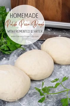 three uncooked pizza doughs sitting on top of a table