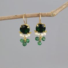 A pair of glowing and dainty clover earrings set with green zircon in copper bezel. Beautiful pearls encircle the lower part of the green zircon, and three striking aventurine gemstones are interwoven gently. This unique earrings design is timeless, so you can enjoy it for years and years to come.  The hook is made of gold filled.  Materials:  Stone: green zircon, pearls, aventurine Metal: gold filled, copper bezel Measurements:  Length including hook: 3cm Width: 15mm Green zircon in diameter: 10mm Since I mostly use natural gemstones, each jewel is unique and therefore there are subtle differences in color and form. Pearl properties: Offers the power of love, money, protection, and luck.  Find more clover earrings here: https://etsy.me/2BSBuLs Click here for more earrings: https://etsy.me Dainty Earrings For Jewelry Making With May Birthstone, Green Dangle Pearl Earrings For Pierced Ears, Green Dainty Dangle Earrings, Dainty Green Dangle Earrings, Green Pearl Drop Earrings For May Birthstone, Single Green Pearl Drop Earrings, Green Gemstone Drop Pearl Earrings, Green Round Pearl Drop Earrings, Green Gemstone Pearl Drop Earrings