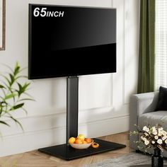 a flat screen tv sitting on top of a black stand