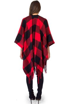 "This cozy chic knit poncho features a bold buffalo plaid print with fringe trim, and lightweight, flowing material that is comfortable and warm. Wear with your favorite boots for a stylish, yet casual look on chilly days. Material: 100% Acrylic Sizing: One size fits all Garment Measurements: 46\" x 55\" Model Measurements: Bust: 32\" Waist: 26\" Hips: 36\" Height: 5'5 See more colors and prints here: https://www.etsy.com/shop/DaisyDelSolDesigns?section_id=24478765 We are taking steps towards su Red Oversized Poncho For Winter, Oversized Red Poncho For Winter, Winter Plaid Poncho, Plaid Winter Poncho, Red Shawl Cape For Fall, Fall Red Shawl Cape, Oversized Plaid Poncho For Fall, Casual Red Cape For Autumn, Casual Red Cape For Fall