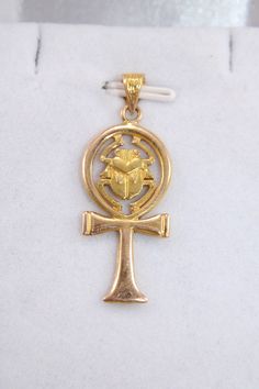 "Egyptian Handmade Ankh Cross Key Of Life + Scarab 18K Yellow Gold Pendant 4 Gr Weight Approximate : 4 Gr Height : 1.1\" = 34 mm Width : 0.5\" = 14 mm ✔ IT IS Tested & SIGNED WITH THE EGYPTIAN Gold Government HALLMARK FOR 18K GOLD to Ensure Authenticity. ✔ Lovely gift idea ABSOLUTELY GORGEOUS, LOOKS FABULOUS ON. ✔ 100% Egyptian handmade. ✔ Condition: A brand-new, exactly as on the photos. ★ GIFTS ✔ All items are packaged in a paper jewelry gift box, ready for gifting. ✔ If you are sending a gift Antique Ankh Jewelry As Gift, Antique Ankh Jewelry Gift, Antique Gold Ankh Jewelry, Antique Ankh Shaped Jewelry Gift, Egyptian Gold, Egyptian Revival Jewelry, Key Of Life, Ankh Cross, Paper Jewelry