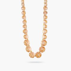 Long necklace with a row of round faceted glass stones in apricot tones, gold-plated brass mounting.The Diamantine, a bespoke faceted glass must-have, is proof of Les Néréides' expertise in high-end costume jewelry. Pair it with the other jewels from the collection to create a matching set. Necklace: Gold-plated brass, hand-enameled and cut glass Length: 65cm Width: 1.5mDepth: 0.8cm Weight: 54.3g ALL SALE ITEMS ARE FINAL SALEAMSO210/1 AMSO210/1 Les Nereides, Brass Hand, Set Necklace, Crystal Stones, High Fantasy, Necklace Necklace, Brass Frame, Faceted Glass, Faceted Crystal