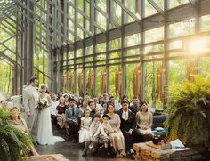 a group of people that are standing in front of a building with lots of windows