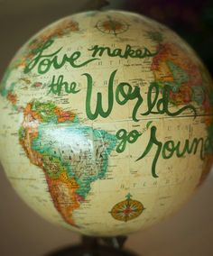 a globe with the words love makes the world go round