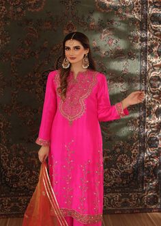 A brigh hot pink rawsilk long shirt minutely handworked with dabka, gota, sequence and zardozi, Paired with matching rawsilk worked Azar pants (Includes Shirt and pants) Pink Raw Silk Sharara With Gota Work, Raw Silk Straight Kurta With Dabka, Festive Raw Silk Lawn Suit With Dabka, Diwali Unstitched Jamawar Suit With Gota Work, Festive Lawn Suit With Dabka On Raw Silk, Pink Raw Silk Sharara With Dabka Work, Bollywood Style Designer Lawn Suit In Slub Silk, Pink Dola Silk Sharara With Dabka Work, Bollywood Style Designer Slub Silk Lawn Suit