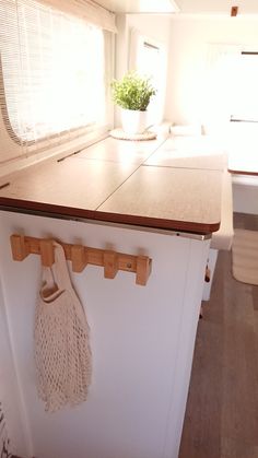 a kitchen counter with a bag hanging on it