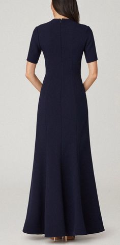 Elegant gown in navy stretch crepe. Style features a sweetheart square neckline and fitted short sleeve. Form fitted silhouette bodice with slightly flared skirt bottom. Bodice lined, skirt unlined. Hidden back zipper. 95% Polyester, 5% Polyurethane. Dry clean only. Color: Navy Elle Dress, Gowns Of Elegance, Stretch Crepe, Fitted Silhouette, Square Necklines, Flared Skirt, Square Neckline, Flare Skirt, Workout Shorts