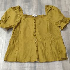 Brand New With Tags Mustard Yellow Madewell Blouse Beautiful Detail In The Sleeves With Buttons All Across The Front Beautiful Elastic Back For Comfortable Wear Size: Oo Brand: Madewell Gold Fitted Casual Blouse, Casual Mustard Cotton Blouse, Mustard Short Sleeve Casual Blouse, Gold Fitted Top For Day Out, Mustard Casual Short Sleeve Blouse, Fitted Gold Top For Day Out, Casual Mustard Short Sleeve Blouse, Casual Gold Blouse For Spring, Casual Gold Blouse For Day Out